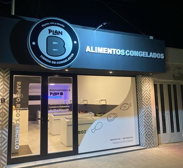 a business sign on a building with a phone in front of it