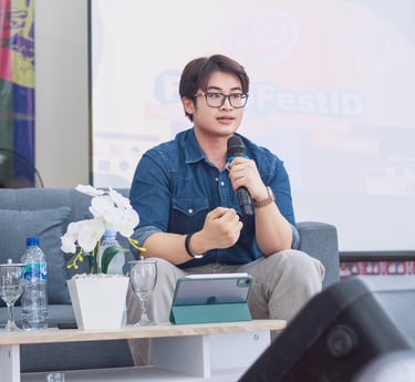 a man in a blue shirt is holding a microphone