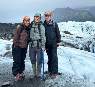Al Belluche with his family stnading on a glacier