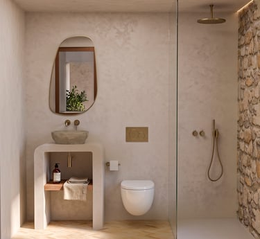 Modern rustic bathroom featuring a stone vessel sink, gold fixtures, and a walk-in shower with stone walls.