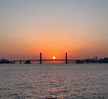 A cozy workspace with a laptop, a cup of Colombian coffee, and sketches of website designs on paper.