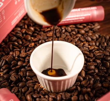 a cup of coffee is being poured with coffee beans