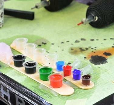 a table with paint and brushes and paint