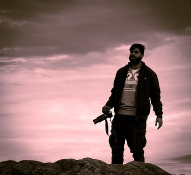 a man standing on a rock with a camera