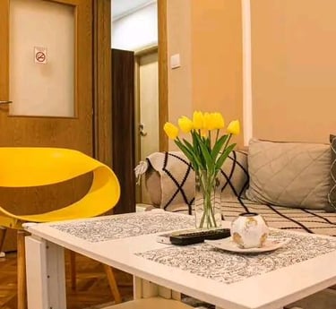 a living room with a couch and a yellow chair