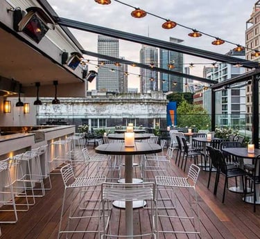 a rooftop bar with a view of the city