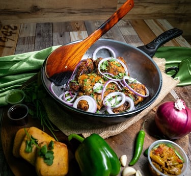 Delicious Indian food, with samosas, tandoori chicken, and curry.