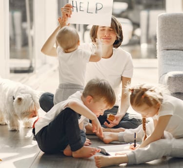 a woman and two children sitting on the floor