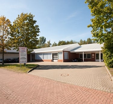 a building with a brick building and trees