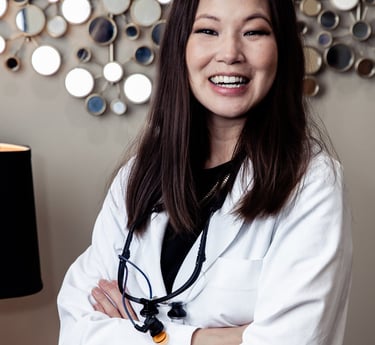 A picture of a smiling dentist, Dr. Oyama.