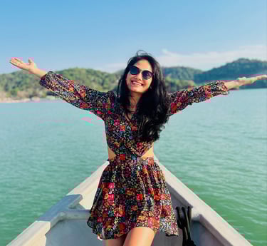 a woman in a dress and sunglasses on a boat