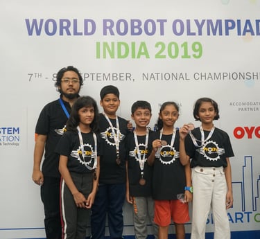 Students wearing medals at the World Robot Olympiad India 2019 National Championship for STEM.