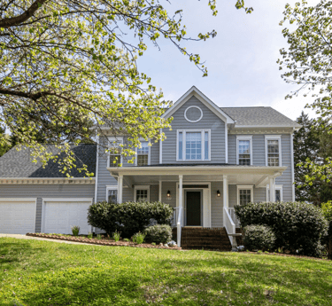 a house with a large front yard and a driveway
