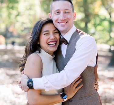 a man and woman are smiling and hugging