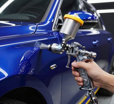 Dramatic close-up of a high-tech spray paint gun applying flawless deep metallic blue paint to a luxury car body under linear LED lights, sharp reflections, 35mm