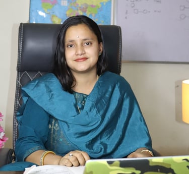 a woman sitting at a desk with a laptop computer