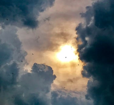 Sunlight breaking through dark storm clouds representing hope and recovery from anxiety n depression