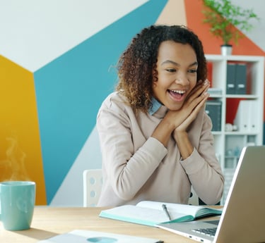 Happy student looking at laptop representing academic success and effective career counseling