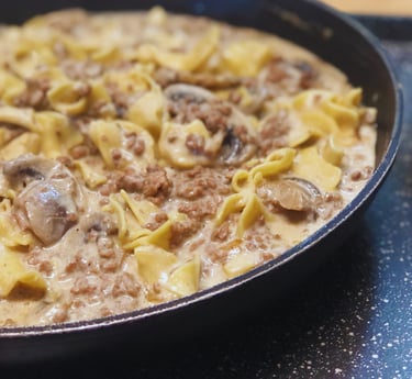 ground beef stroganoff in black pan with mushrooms