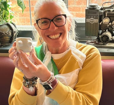 a woman showing off her boob pot she made