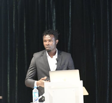a man in a suit and tie is standing at a podium