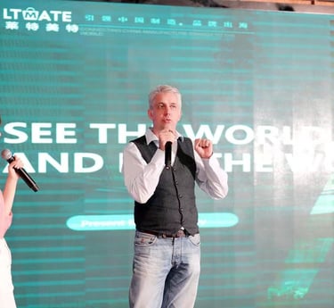 a man and woman standing in front of a large screen