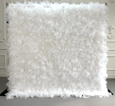 Elegant white ruffled tulle backdrop for wedding and event decor.