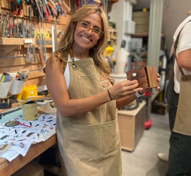 Adult participant holding a handmade wooden watch box during a beginner woodworking workshop at Lamm