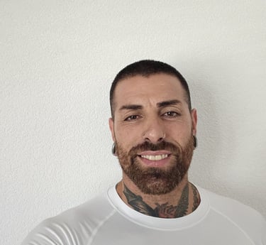 a man with a beard and tattoos on his chest