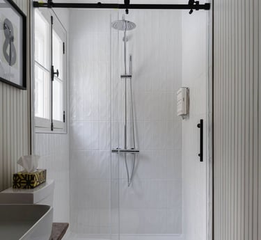 a bathroom with a toilet and a shower