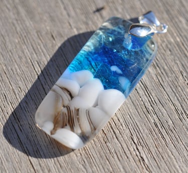 a blue and white fused glass pendant