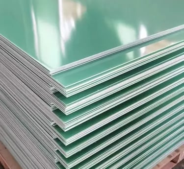 Stack of green epoxy resin fiberglass FR4 sheets on a wooden pallet for industrial insulation.