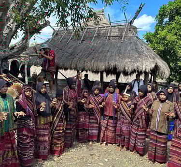 Tribe in Bampalola village singing and dancing in alor in front of their traditional house