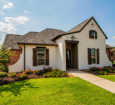 Photo of rancher style house basking in mid-day sunshine.