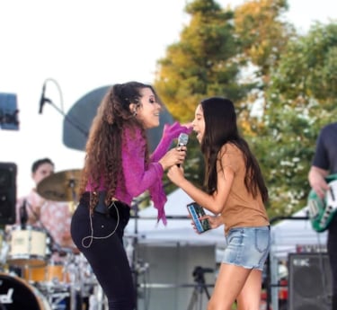 Lady Ivy singing with fan