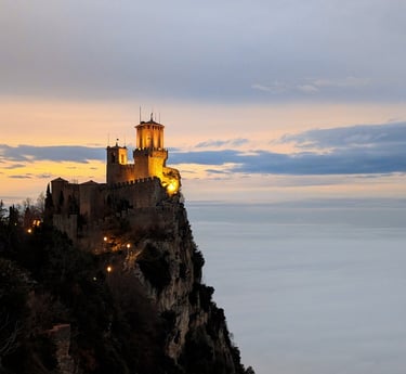 One of San Marino's towers overlooking clouds at sunset