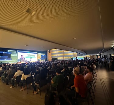 a large group of people sitting in chairs in a room