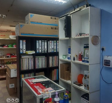 Suasana Aircond professional office, service counter, and Daikin parts stock.