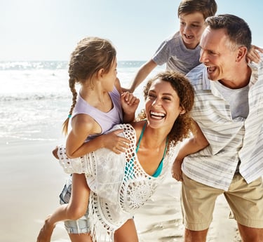 Happy family on the beach making the most of the day