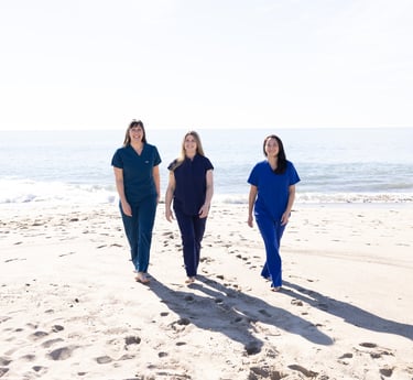 Our three doctors walking on the beach.