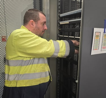 Sam Murphy, Managing Director of Easy Spark Ltd, installing fibre optic and CAT6 patch panels.