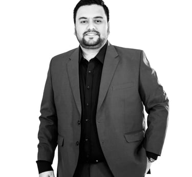 a man in a suit and tie is standing in front of a white background