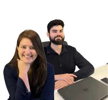 a man and woman sitting at a table with laptops