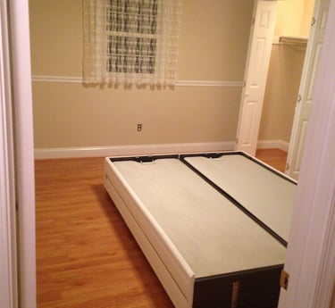 Wood-look laminate flooring installed throughout a hallway and adjoining rooms in a home.