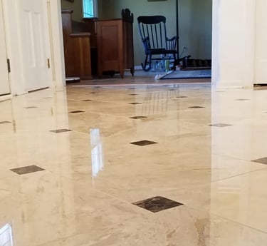 professionally installed polished marble tiles accented with contrasting dark inlays.