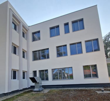 a building with a large window and a sculpture of a sculpture