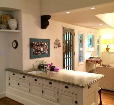 Elegant white kitchen island with granite countertop and classic cabinets in a warm home interior.