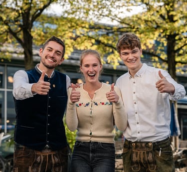 three people standing next to each other with thumbs up
