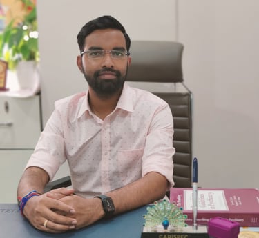 Professional male psychiatrist in glasses sitting at a clinic desk with psychiatric medical books.