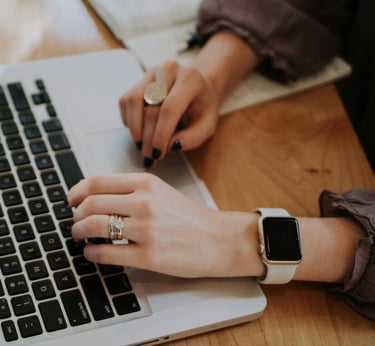 a woman's hands on a laptop computer